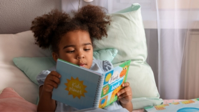 Little girl reading on couch