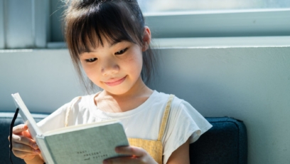 Girl reading with a slight smile