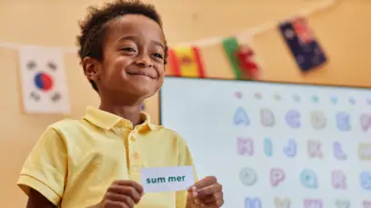 Boy Smiling While Holding Paper