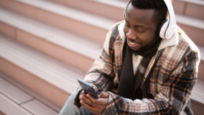 Man wearing headphones looking at his phone