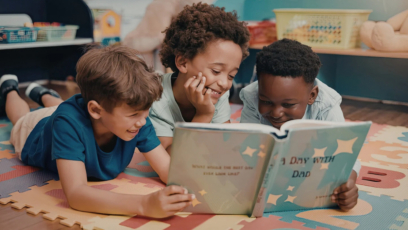 3 boys reading together in a classroom
