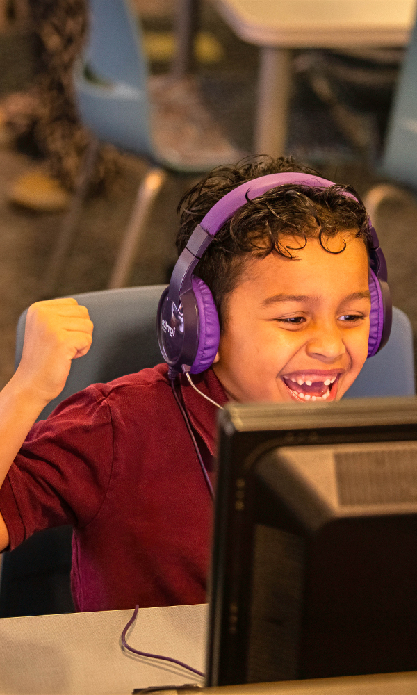 Happy Boy Interacting With Ignite Reading Tutor