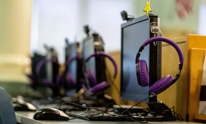 student headphones hang from Computers