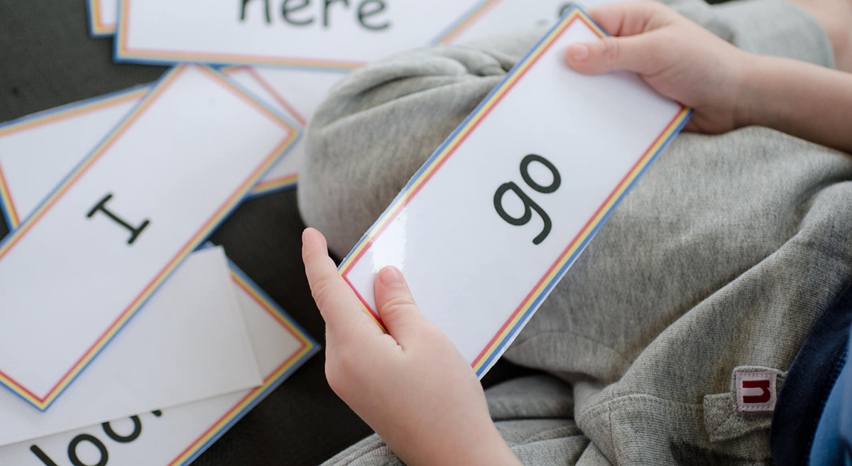 A child holds Sight Words Flashcards during a reading lesson
