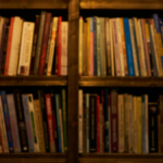 Systematic organization of books along shelves in a darkened room
