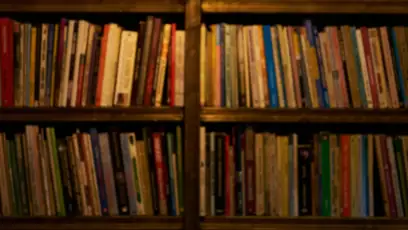 Systematic organization of books along shelves in a darkened room