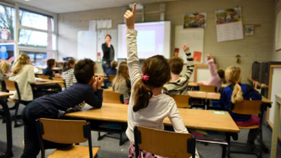 Teacher Giving A Lesson And Student Raising Her Hand