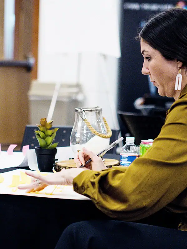 ROI of Reading Interventions — Proving Impact in Student Outcomes & District Budgets 7 elementary teacher working on professional learning at her desk in a classroom