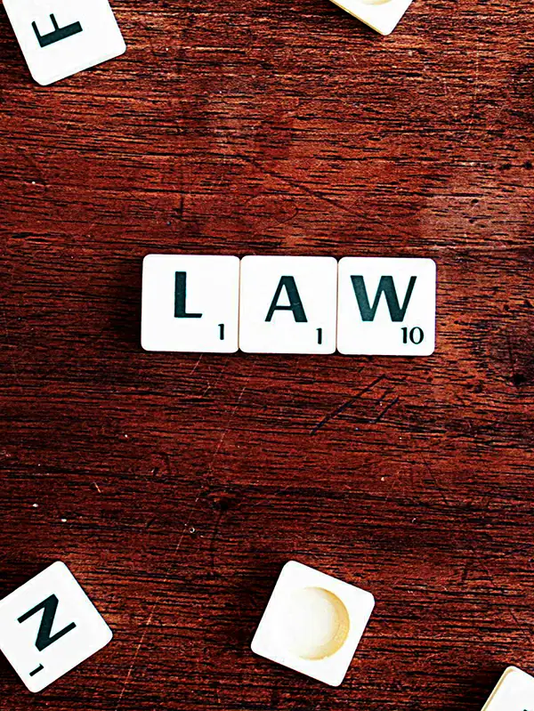 High-Impact Tutoring Program Tips for School Districts — How to Maximize Effectiveness 5 Letter tiles on a desk spell out the word law