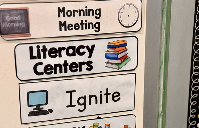 A classroom schedule with students' tutoring time on an elementary classroom wall 