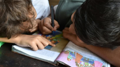 Two Boys Reading Together