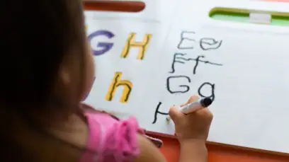 Young Student Writing Alphabet